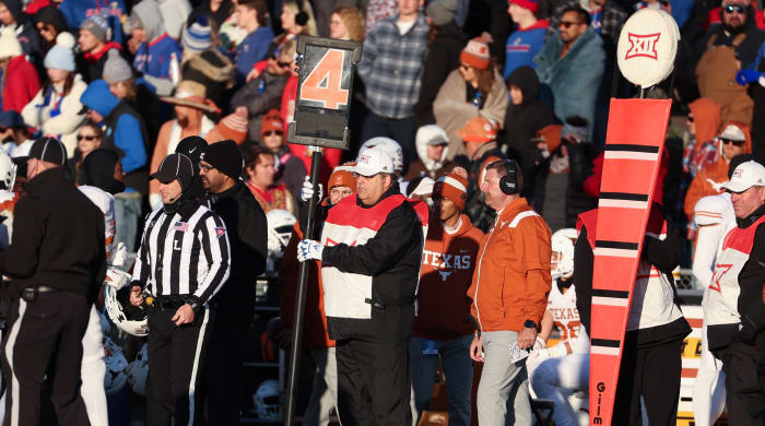 A college football chain gang holds the sticks